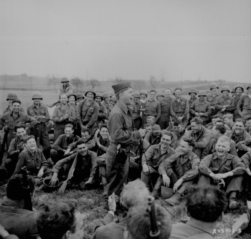 Mickey Rooney imitates some Hollywood actors for an audience of Infantrymen of the 44th Division.
