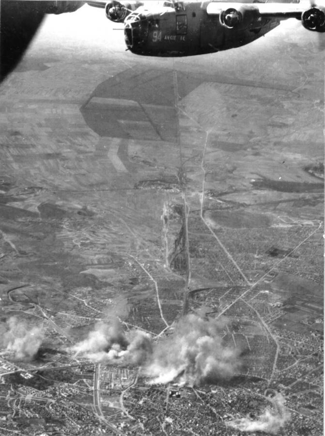 “Angie the Ox”, a B-24D Liberator over the smoking rail yards in Bucharest, Romania
