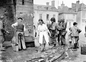 American soldiers stand at the village fountain, Sainte-Marie-du-Mont